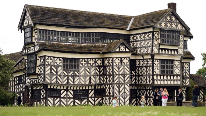 Visitors outside the house at Little Moreton Hall, Cheshire